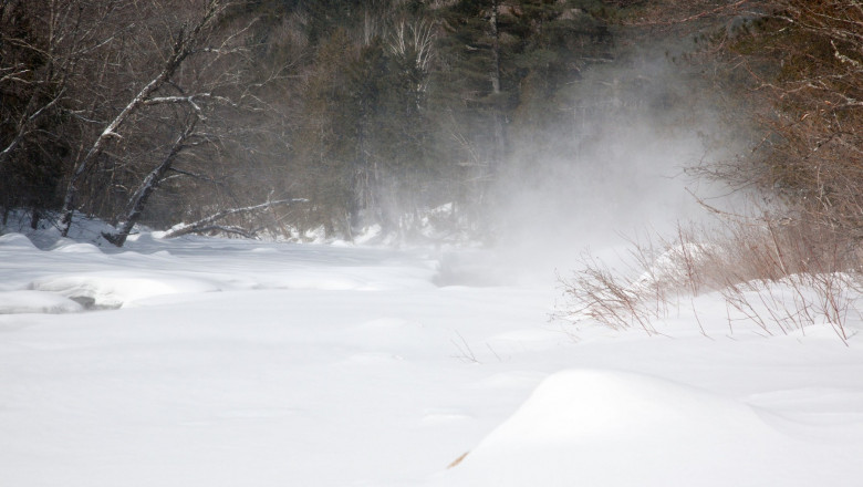 Strong winds blow snow across the East Branch of the Pemigewasset River in the Pemigewasset Wilderness of Lincoln, New Hampshire