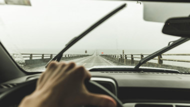 Driver's point of view inside car cruising down two-lane bridge in Washington, USA.