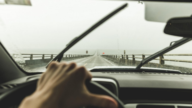 Driver's point of view inside car cruising down two-lane bridge in Washington, USA.