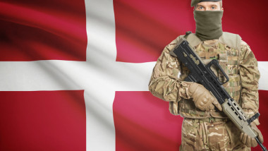 Soldier holding machine gun with flag on background series - Denmark