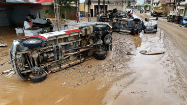 vehicles overturned on a street covered by mud after heavy rains hit the southeastern region of Brazil