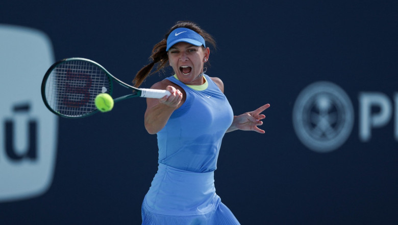 Simona Halep of Romania returns a shot to Paula Badosa of Spain during her women's singles match during the Miami Open