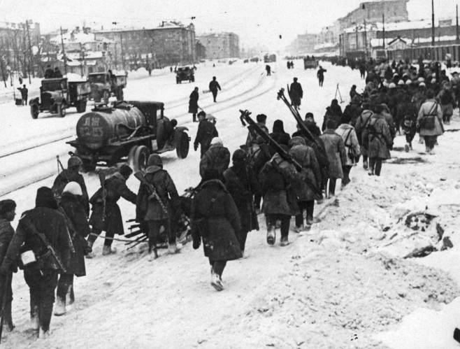 Replacement Russian troops heading to the Front through the streets of the encircled city, during the siege of Leningrad, 1940s