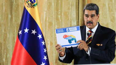 Nicolas Maduro holding map speaks during an act to present the Organic Law for the Defense of "Guyana Esequiba" at the National Assembly in Caracas on April 3
