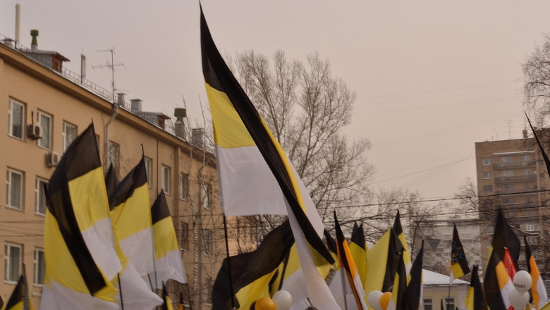 Waving flags of Russian nationalists (old Russian imperial flags)