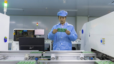 JIUJIANG, CHINA - APRIL 07: An employee works on the production line of printed circuit board assembly (PCBA) at a works