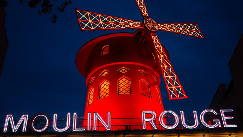 facade of the Moulin Rouge, a famous cabaret and theatre at night in Paris.