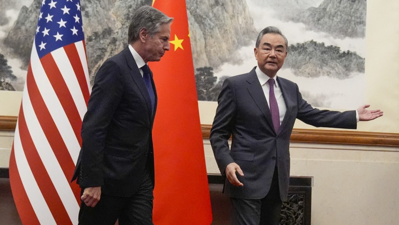 US Secretary of State Antony Blinken (L) follows China's Foreign Minister Wang Yi (R) during a meeting at the Diaoyutai State Guesthouse in Beijing