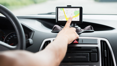 Close-up,Of,Female's,Hand,Using,Gps,Navigation,Inside,Car