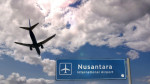 Airplane silhouette landing in Nusantara, Indonesia. City arrival with international airport direction signboard and blue sky. Travel, trip and transp