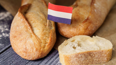 Augsburg, Bavaria, Germany - March 16, 2024: fresh French baguette bread with a France flag. Symbolic image of bread and baguette from France *** frisches franzsisches Baguette Brot mit einer Frankreich Fahne. Symbolbild Brot und Baguette aus Frankreich