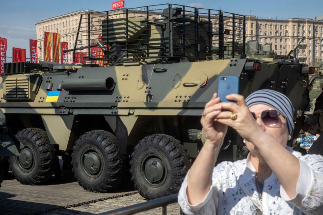 Moscow, Russia. 30th of April, 2024. A woman takes selfie on Moscow's Poklonnaya Hill where military hardware captured by Russian servicemen in the zone of Russia's special military operation, in Moscow, Russia