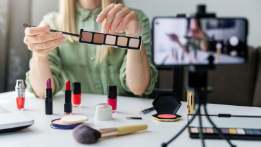 makeup beauty fashion blogger influencer recording video presenting cosmetics on social media at home