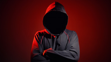 Silhouette,Af,Man,Without,Face,In,Hood,On,A,Red