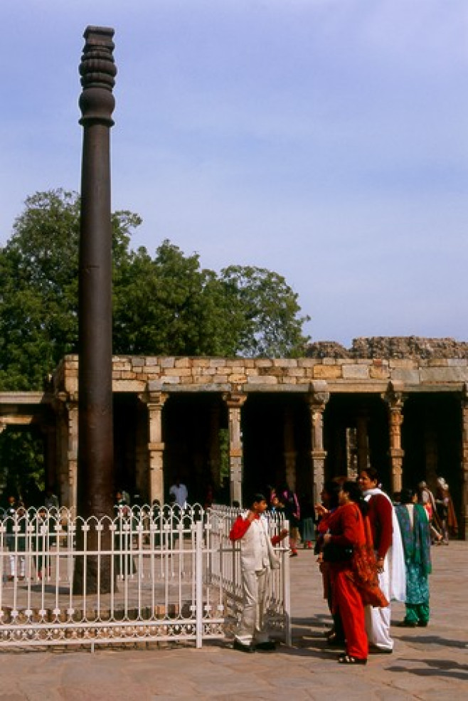 India: The almost 2,000 year old Iron Pillar at the Qutb Minar complex, Delhi