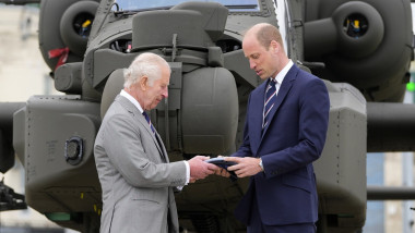 Britain's King Charles III officially hands over the role of Colonel-in-Chief of the Army Air Corps to Prince William, The Prince of Wales in front of an Apache helicopter at the Army Aviation Centre in Middle Wallop, England
