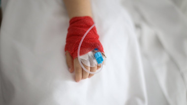 Details with a cannula on the hand of a ill little girl in a pediatric hospital reserve
