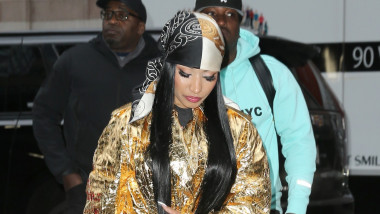 Nicki Minaj arrives at Watch What Happens Live in a gold coat and matching Louis Vuitton bag