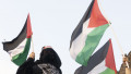 A pro-Palestinian activist holds a Palestine flag during a rally