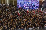 Iranian officials adjust the coffin of late President Ebrahim Raisi during a funeral procession ceremony at the Mossalla