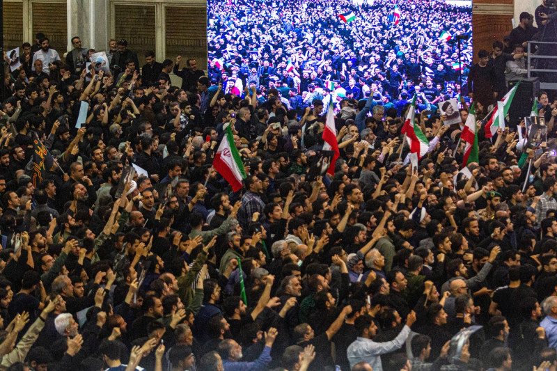 Iranian officials adjust the coffin of late President Ebrahim Raisi during a funeral procession ceremony at the Mossalla