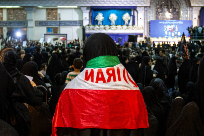 Iranian officials adjust the coffin of late President Ebrahim Raisi during a funeral procession ceremony at the Mossalla