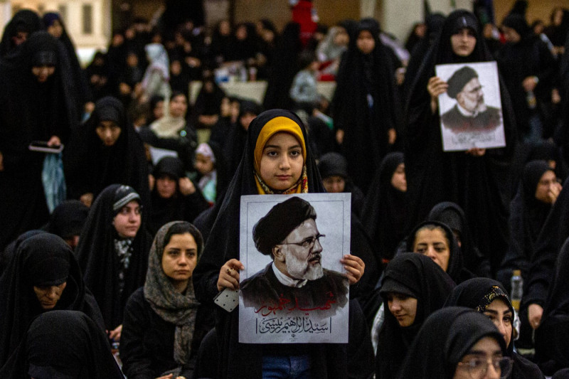 Iranian officials adjust the coffin of late President Ebrahim Raisi during a funeral procession ceremony at the Mossalla