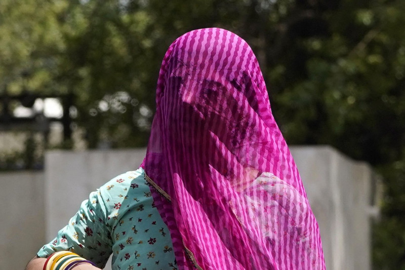 Indian People covers head with a cloth to shelter from the heat on a summer afternoon in Ajmer, Rajasthan, India on May 27, 2024. Two persons were reported to be victims of the intense heatwave in Rajasthan as the state continued to witness sweltering hea