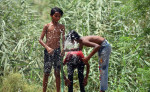 GURUGRAM, INDIA - MAY 29: Children takes bath on a hot summer day at Dwarka Expressway near sector-99 on May 29, 2024 in