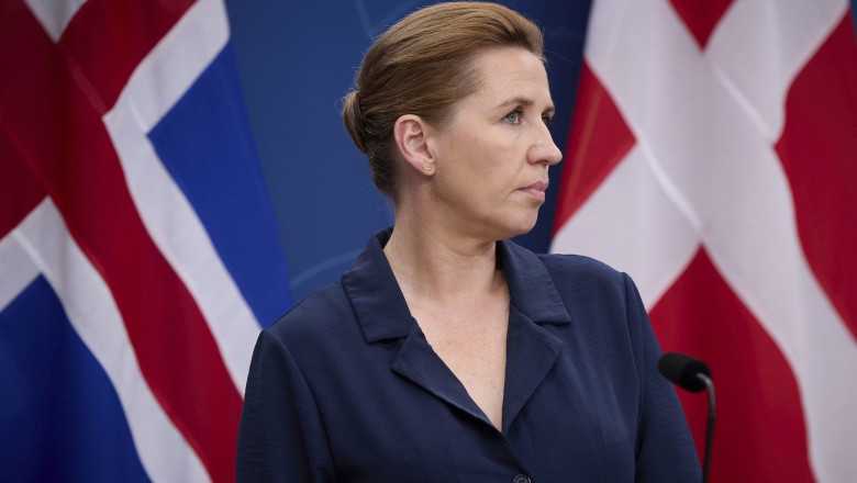 Danish Prime Minister Mette Frederiksen listens to a question during a press conference