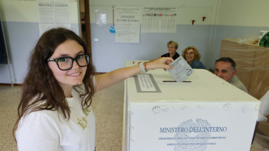 Alegătoare depune buletinul de vot într-o urnă