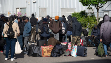 Asylum seekers queue to be registered by members of associations to get a place to stay in in the Ile-de-France region, during the evacuation of France's biggest squat, which has housed up to 450 migrants, most of them legal migrants according to associat