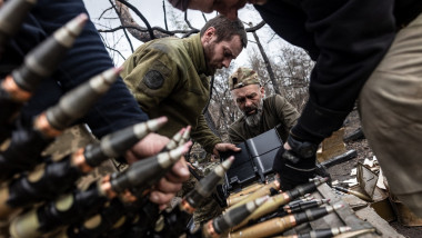 Ukrainian soldiers prepare shells for a BMP during a training