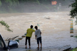 Rianstorm Hit Liuzhou Of Guangxi LIUZHOU, CHINA - JUNE 14, 2024 - Villagers observe floods at the bridgehead of Datan Tu