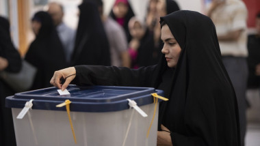 A woman casts her ballot during the Iranian presidential election in a polling station
