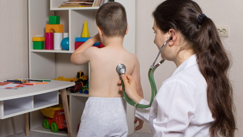 Pediatric examination of a child with a stethoscope. Little boy and pediatrician.