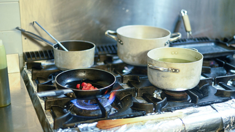 A stove top with a pan on it and a pot on top of it