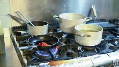 A stove top with a pan on it and a pot on top of it