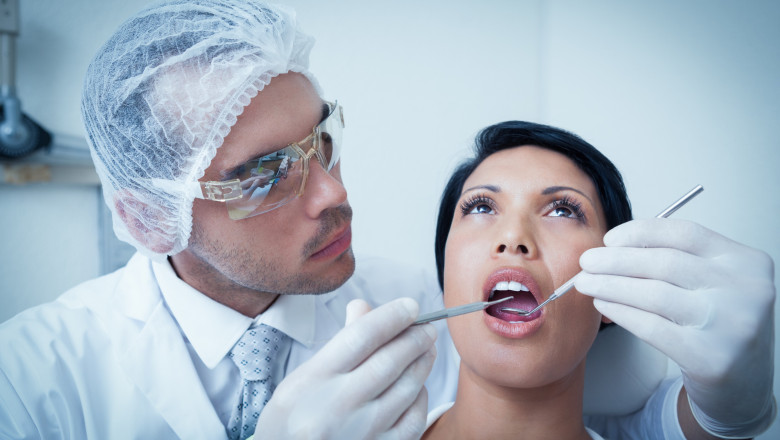 Male dentist examining womans teeth