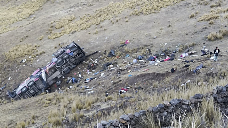 Dead bodies and debris lie on a hillside next to a wrecked bus that plunged down a ravine on a remote site in the Andes, Peru,