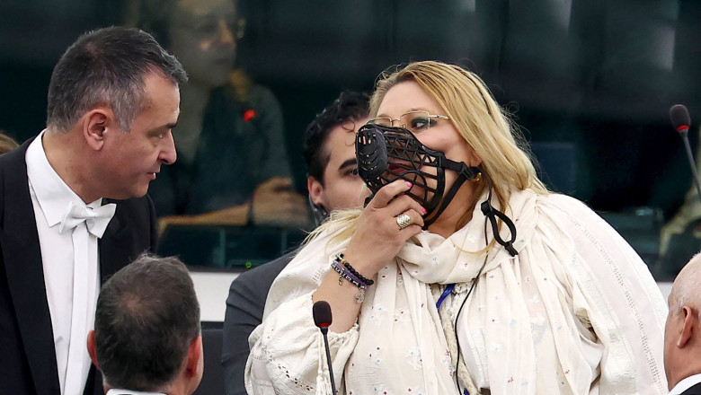 MEP Diana Iovanovici Sosoaca (R) wears a muzzle in european parliamnent