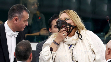 MEP Diana Iovanovici Sosoaca (R) wears a muzzle in european parliamnent