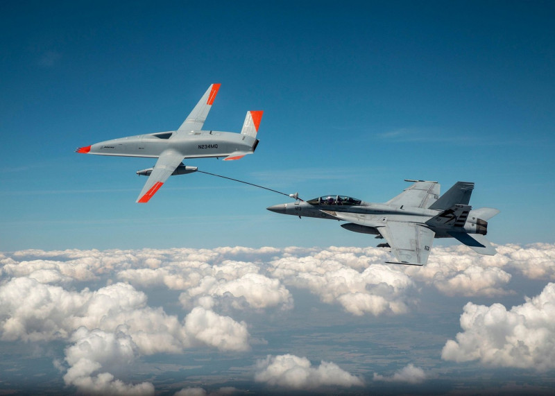 A U.S. Air Force unmanned Boeing MQ-25 T1 Stingray test aircraft, left, refuels a manned F/A-18 Super Hornet fighter aircraft during flight tests over MidAmerica Airport June 4, 2021 in Mascoutah, Illinois. The successful flight demonstrated that the MQ-2