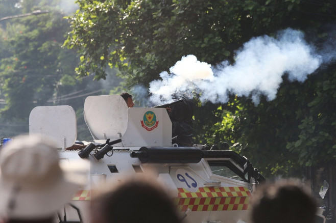 Bangladesh police personnel fire tear shells as students protest against quotas in government jobs at Dhaka University in the capital on July 17, 2024