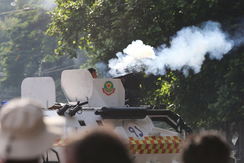 Bangladesh police personnel fire tear shells as students protest against quotas in government jobs at Dhaka University in the capital on July 17, 2024