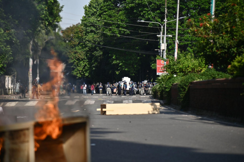 Bangladesh police personnel fire tear shells as students protest against quotas in government jobs at Dhaka University in the capital on July 17, 2024