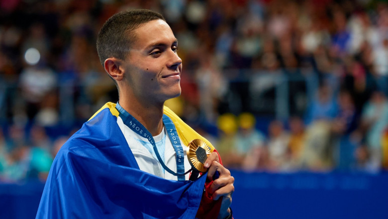 David Popovici of Romania celebrates his gold medal during the Men's 200m Freestyle Medal Ceremony on day three of the Olympic Games Paris 2024