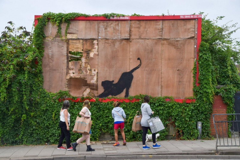 London, UK. 10th August 2024. Crowds gather around a new artwork by Banksy on an old billboard in Cricklewood. The artwork, depicting a wild cat like a tiger or leopard, is the sixth new artwork in as many days in London by the elusive street artist. Cred