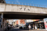 Banksy three swinging monkeys on railway bridge Brick Lane in Shoreditch London, 13th August 2024, part of his zoo collection