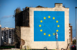 A mural by graffiti artist Banksy depicting a worker chiselling away a star representing the UK on an EU flag following Brexit in Dover, Kent, UK.